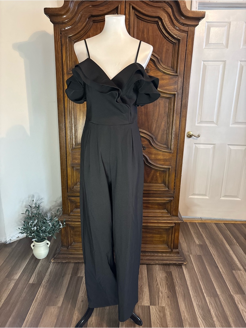 Main strip Black cold shoulder jumpsuit with ruffle detail